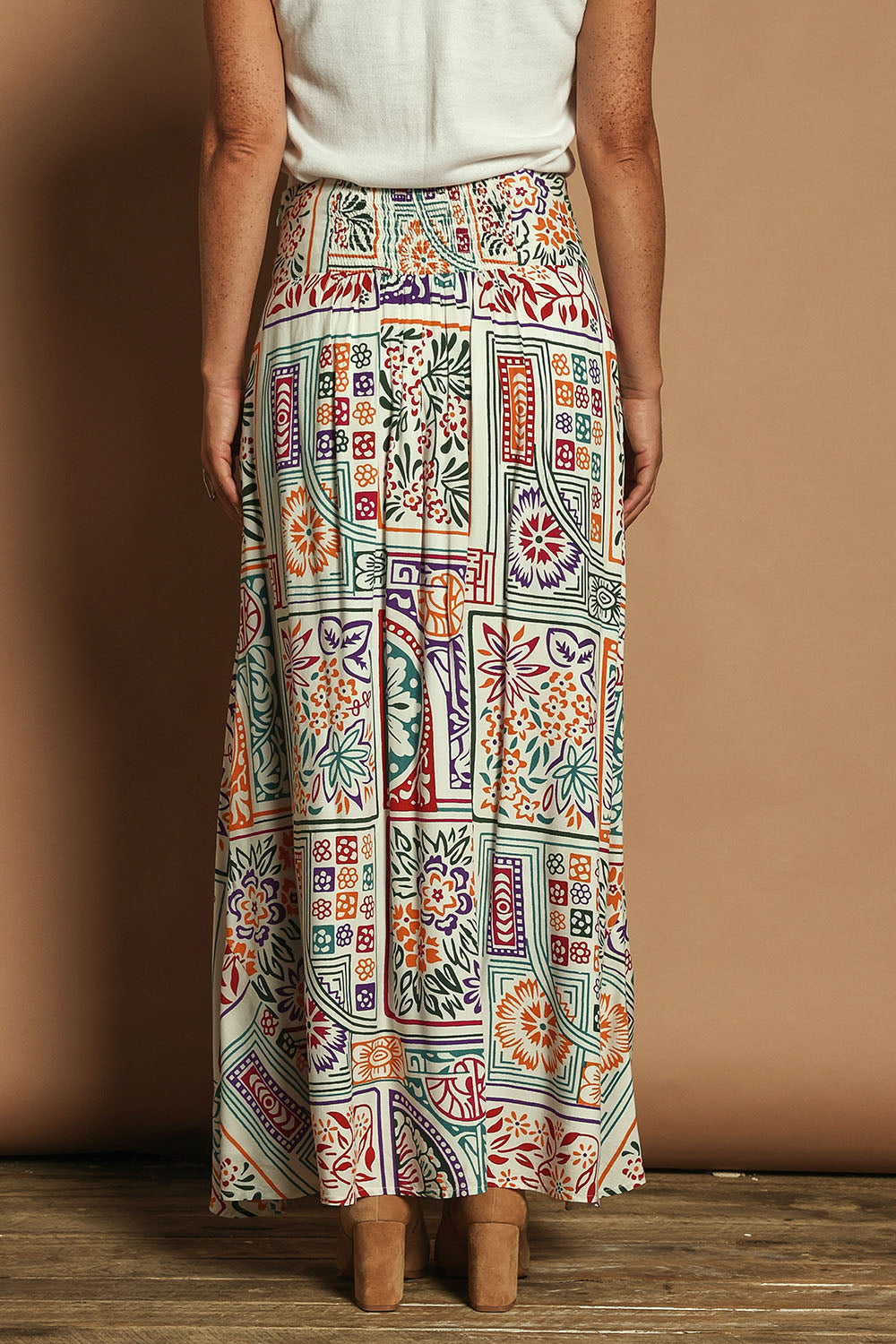 Model Katie wearing size 10 of the Rosie Maxi Skirt in colour Labyrinth, from the back