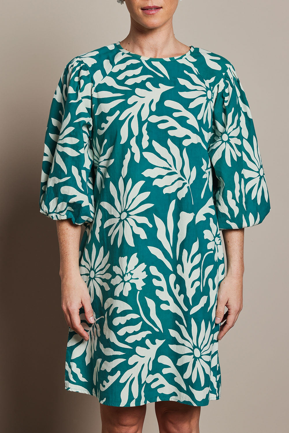 Model Katie wearing size 10 of the Josephine Cotton Dress in colour Gerbera (Green), from the front, cropped image