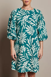 Model Katie wearing size 10 of the Josephine Cotton Dress in colour Gerbera (Green), from the front, cropped image
