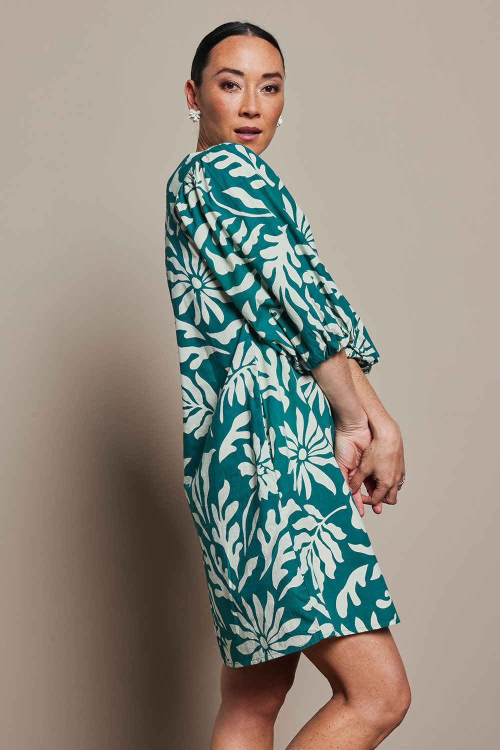 Model Katie wearing size 10 of the Josephine Cotton Dress in colour Gerbera (Green), from the front, cropped image