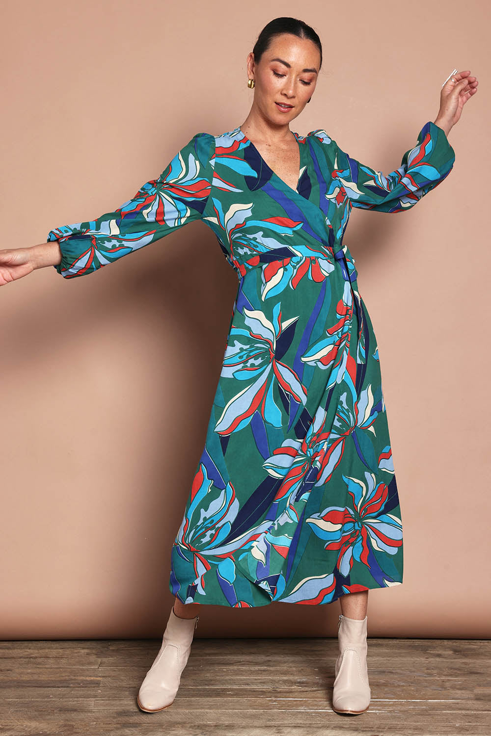 Model Katie wearing size 10 of the Derek Wrap Midi Dress in colour Petalrush, from the front, showing the whole outfit