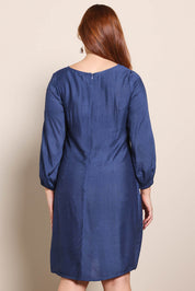 Model Georgiel wearing size 10 of the Isabella Shift Dress – Foxglove in colour Foxglove, from the back