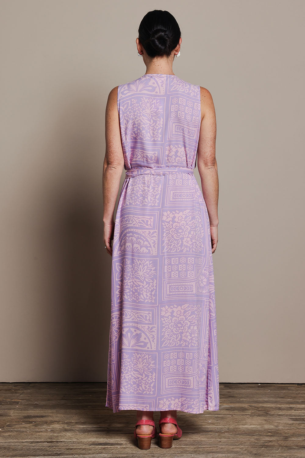 Model Katie wearing size 10 of the Georgina Wrap Dress in colour Labyrinth (Purple), from the back