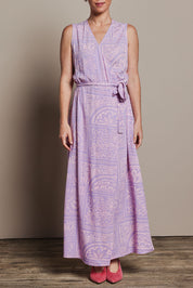 Model Katie wearing size 10 of the Georgina Wrap Dress in colour Labyrinth (Purple), from the front, cropped image