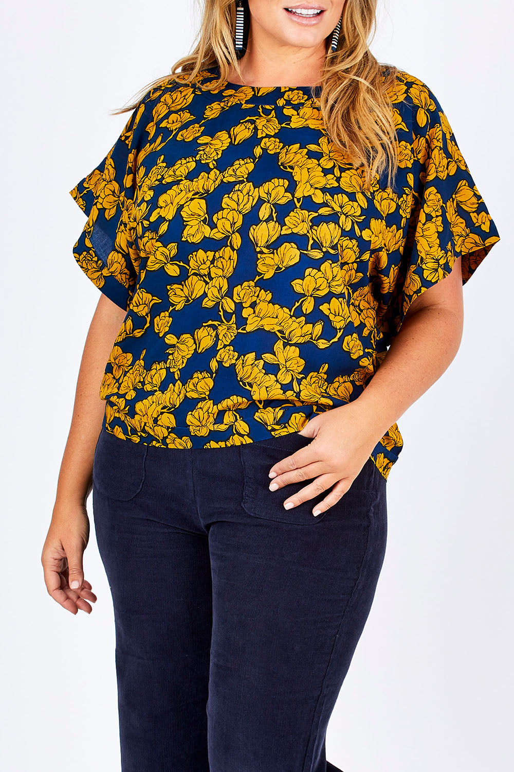 Model Fiona wearing size 16 of the Lola Bell Sleeve Top Entangled Vines in colour Gold, from the front, cropped image