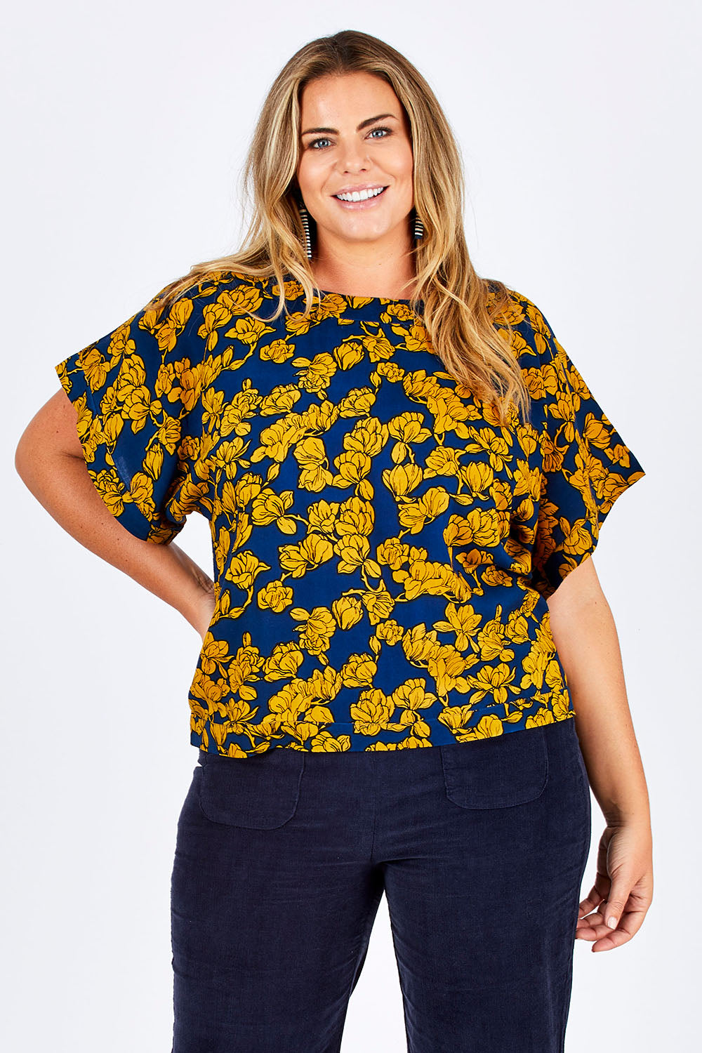 Model Fiona wearing size 16 of the Lola Bell Sleeve Top Entangled Vines in colour Gold, from the front, cropped image