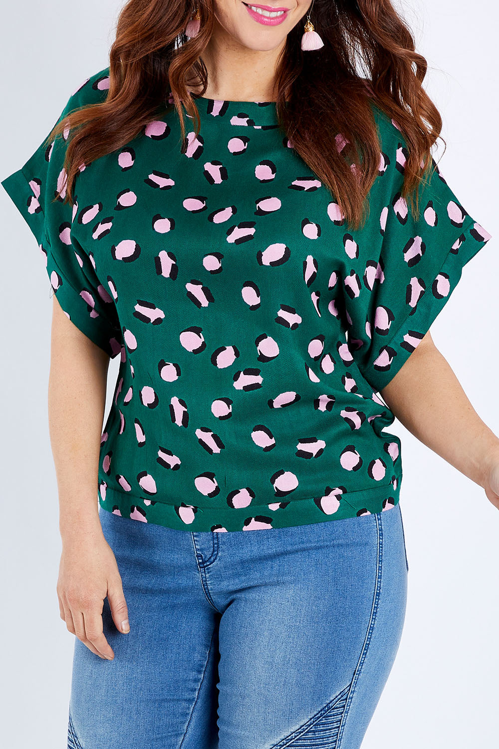Model Laura wearing size 14 of the Lola Belle Sleeve Top in colour Leopard (Green), from the front, cropped image