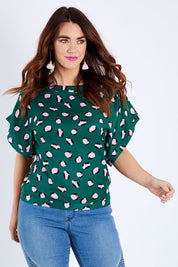 Model Laura wearing size 14 of the Lola Belle Sleeve Top in colour Leopard (Green), from the front, cropped image