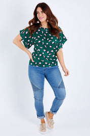 Model Laura wearing size 14 of the Lola Belle Sleeve Top in colour Leopard (Green), from the front, showing the whole outfit