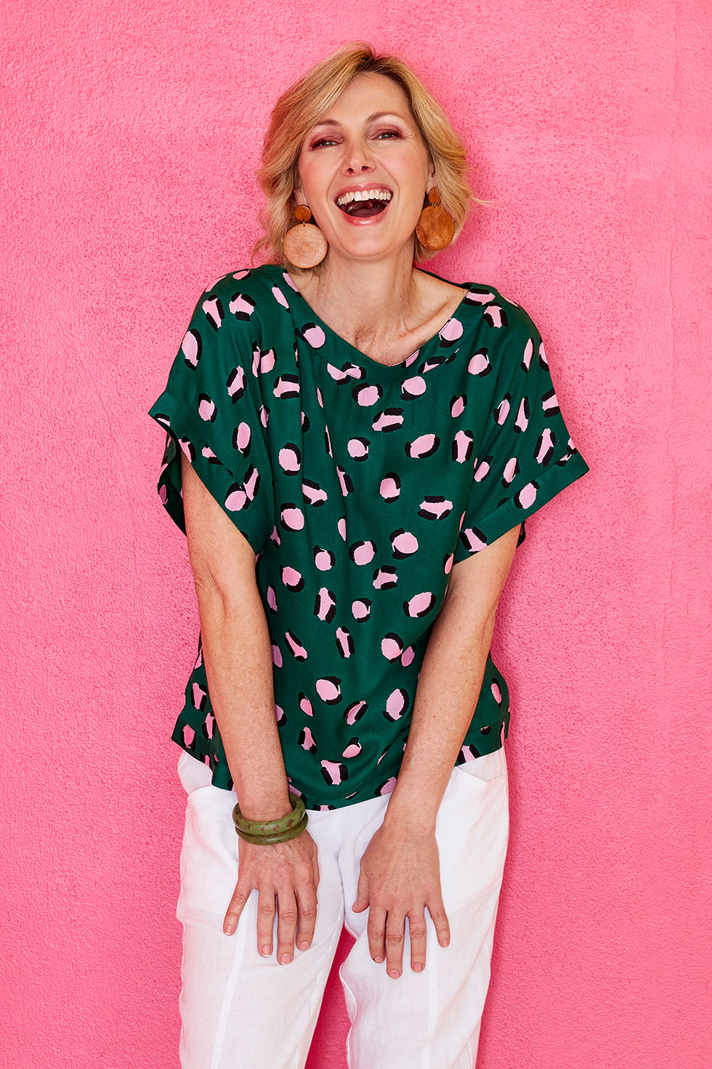 Model Veronica wearing size 10 of the Lola Belle Sleeve Top in colour Leopard (Green), from the front, showing the whole outfit