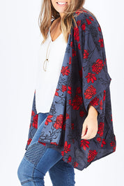Model Natalia wearing size 14 of the Viola Kimono Radiant Floral in colour Grey (Grey), from the front, cropped image