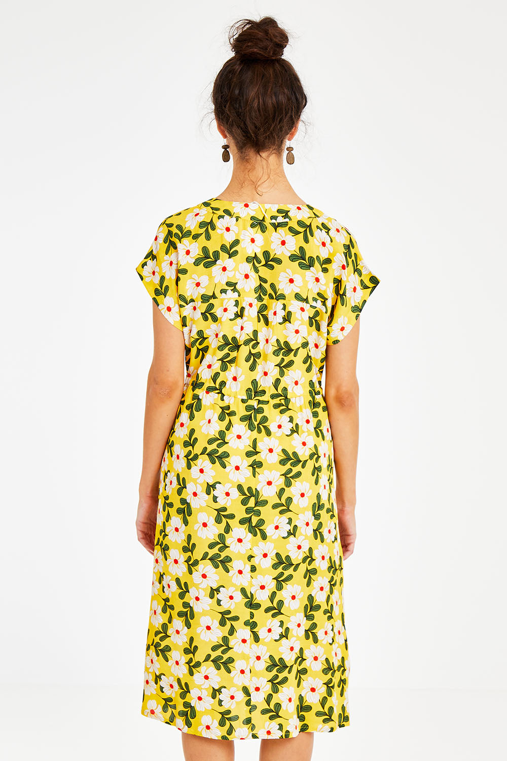 Model Courtney wearing size 10 of the Caroline Drawstring Waist Dress in colour Floral, from the back
