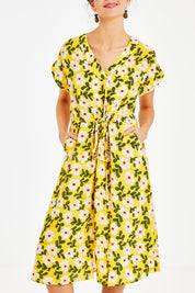 Model Courtney wearing size 10 of the Caroline Drawstring Waist Dress in colour Floral, from the front, cropped image