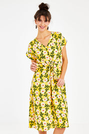 Model Courtney wearing size 10 of the Caroline Drawstring Waist Dress in colour Floral, from the front, cropped image