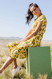 Model Vitoria wearing size 10 of the Caroline Drawstring Waist Dress in colour Floral, from the front, showing the whole outfit