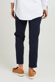 Model Emma wearing size S of the Pull On Pant in colour Navy (Blue), from the back