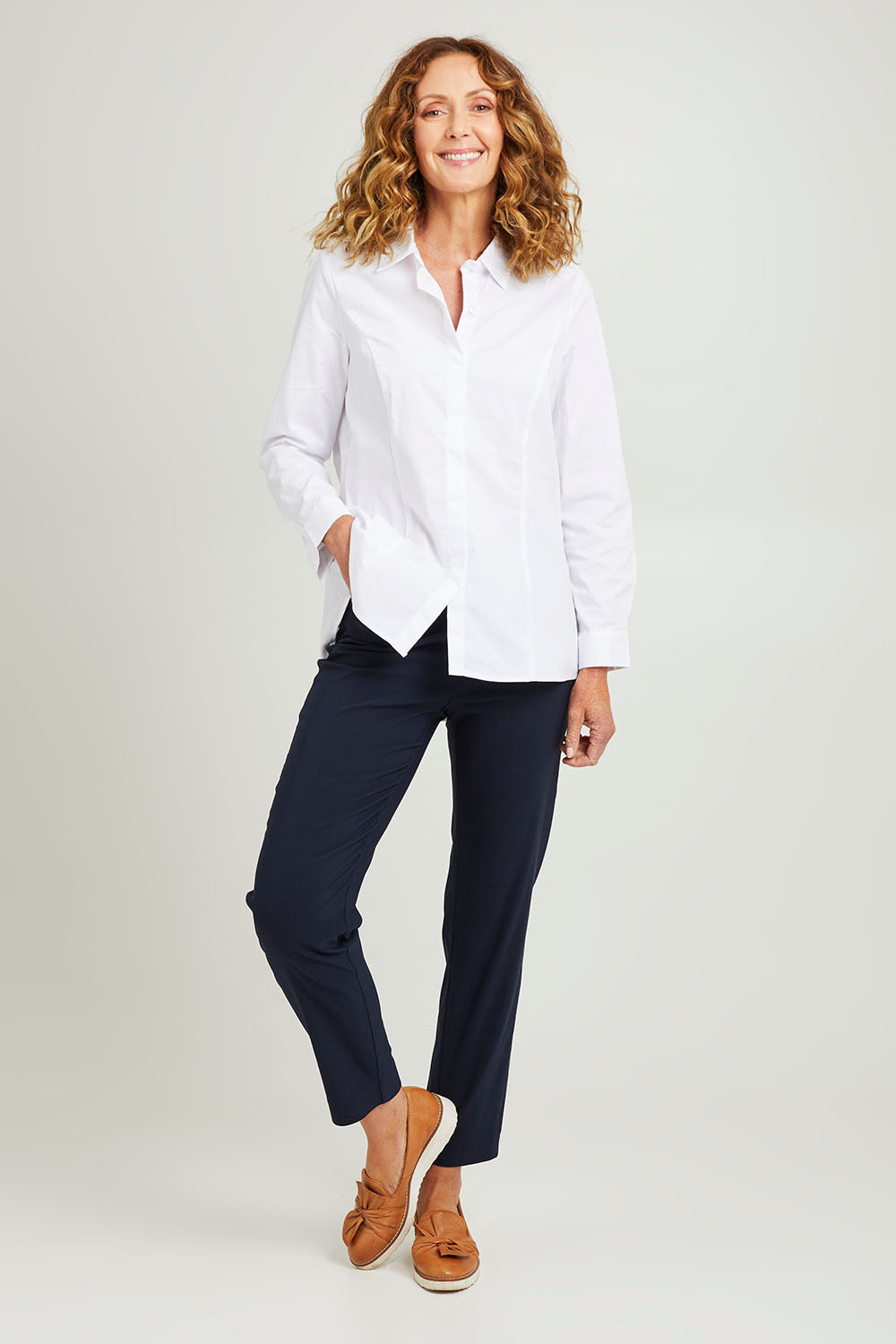 Model Emma wearing size S of the Pull On Pant in colour Navy (Blue), from the front, showing the whole outfit