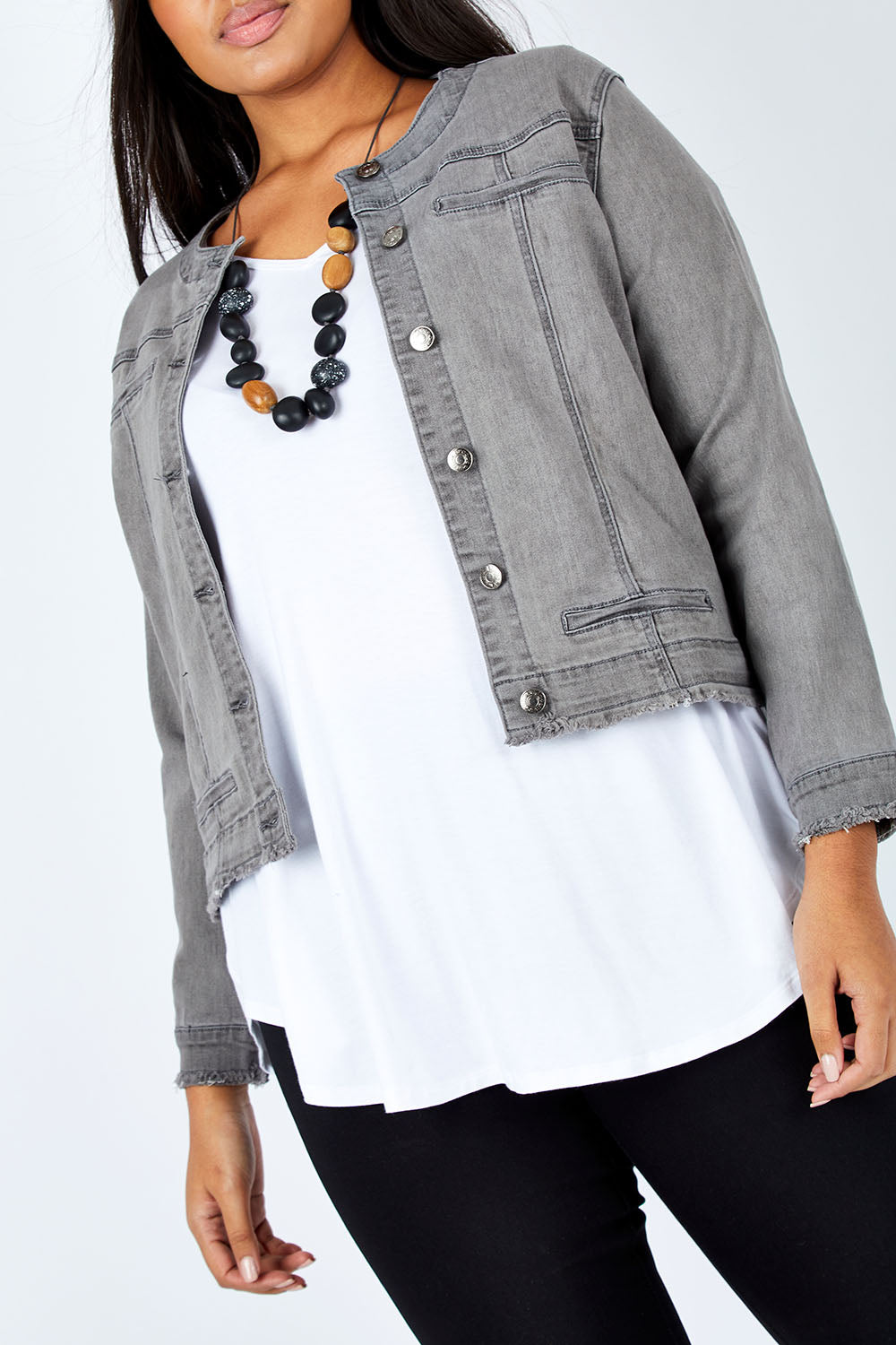 Model Shanaya wearing size L of the Collarless Jacket in colour Charcoal (Grey), from the front, cropped image