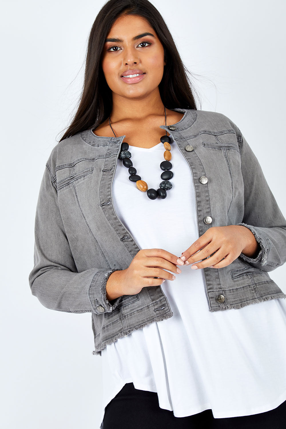 Model Shanaya wearing size L of the Collarless Jacket in colour Charcoal (Grey), from the front, cropped image
