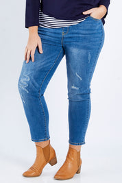 Model Fiona wearing size XL of the Pull On Ripped Jeans in colour Denim (Blue), from the front, cropped image