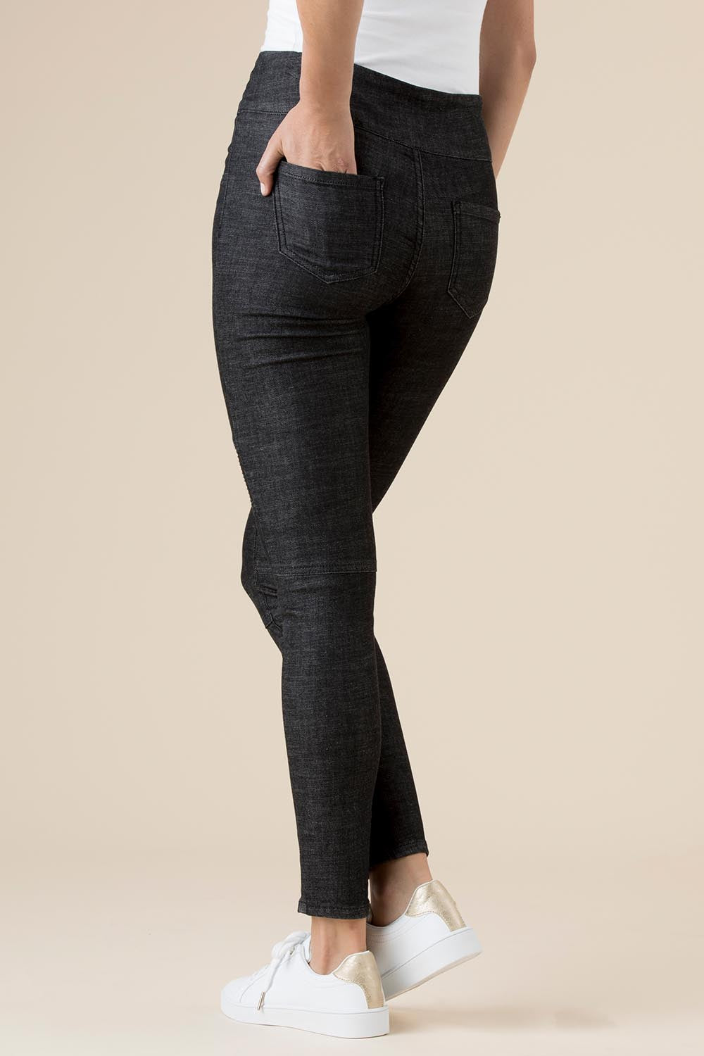 A model wearing the Battered Pull On Jean in colour Black (Black), from the back
