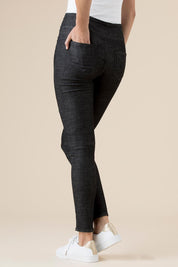A model wearing the Battered Pull On Jean in colour Black (Black), from the back