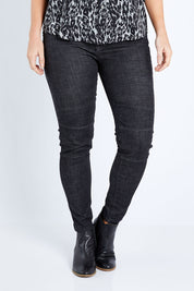 Model Laura wearing size M of the Battered Pull On Jean in colour Black (Black), from the front, cropped image
