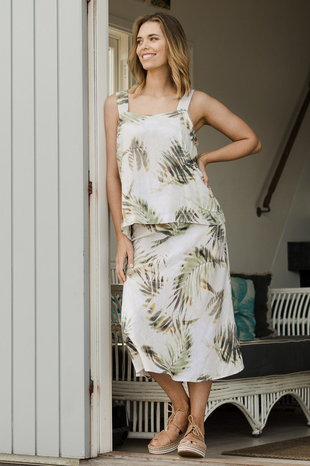 Model Phoebe wearing size S of the Palm Print Skirt in colour Print (Green), from the front, showing the whole outfit