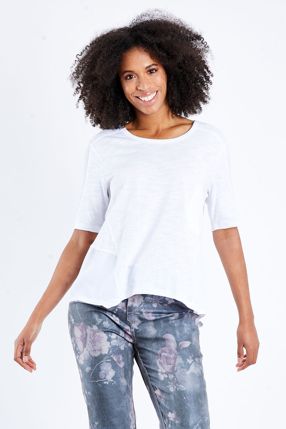 Model Schanez wearing size S of the Short Sleeved Tee in colour White (White), from the front, cropped image
