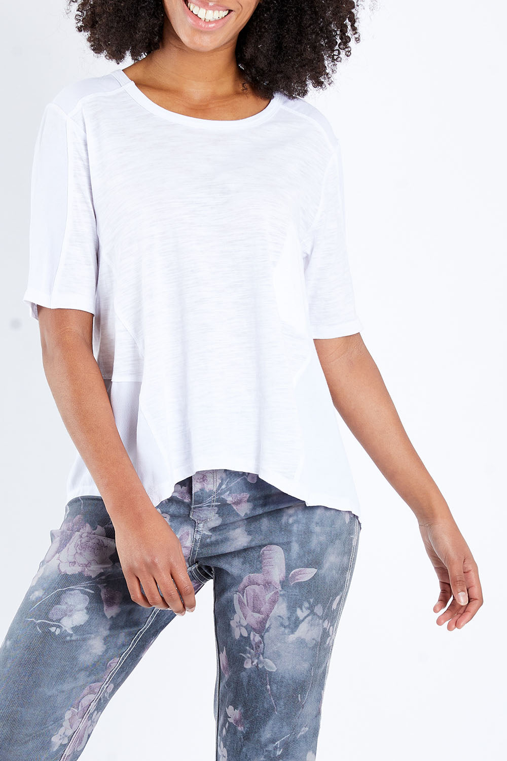 Model Schanez wearing size S of the Short Sleeved Tee in colour White (White), from the front, cropped image