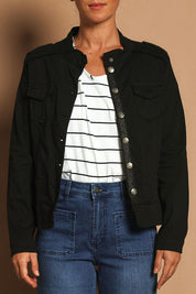 Model Katie wearing size S of the Military Denim Jacket in colour Black (Black), from the front, cropped image