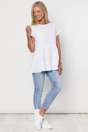 A model wearing the Tiered Tunic in colour White (White), from the front, showing the whole outfit