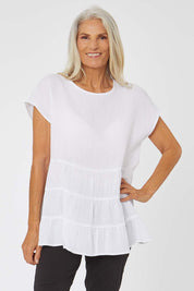 Model Rachel wearing size S of the Tiered Tunic in colour White (White), from the front, cropped image