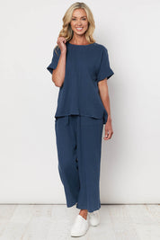 A model wearing the Cotton Pant in colour Navy (Blue), from the front, showing the whole outfit
