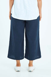 Model Laura wearing size L of the Cotton Pant in colour Navy (Blue), from the back