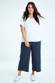 Model Laura wearing size L of the Cotton Pant in colour Navy (Blue), from the front, showing the whole outfit
