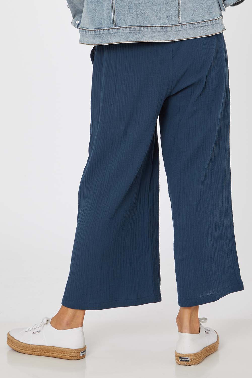 Model Rachel wearing size S of the Cotton Pant in colour Navy (Blue), from the back