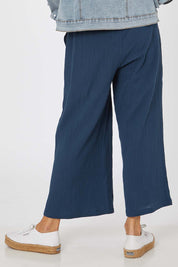 Model Rachel wearing size S of the Cotton Pant in colour Navy (Blue), from the back