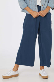 Model Rachel wearing size S of the Cotton Pant in colour Navy (Blue), from the front, cropped image