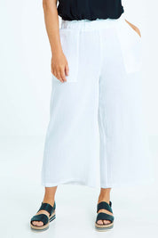Model Laura wearing size L of the Cotton Pant in colour White (White), from the front, cropped image