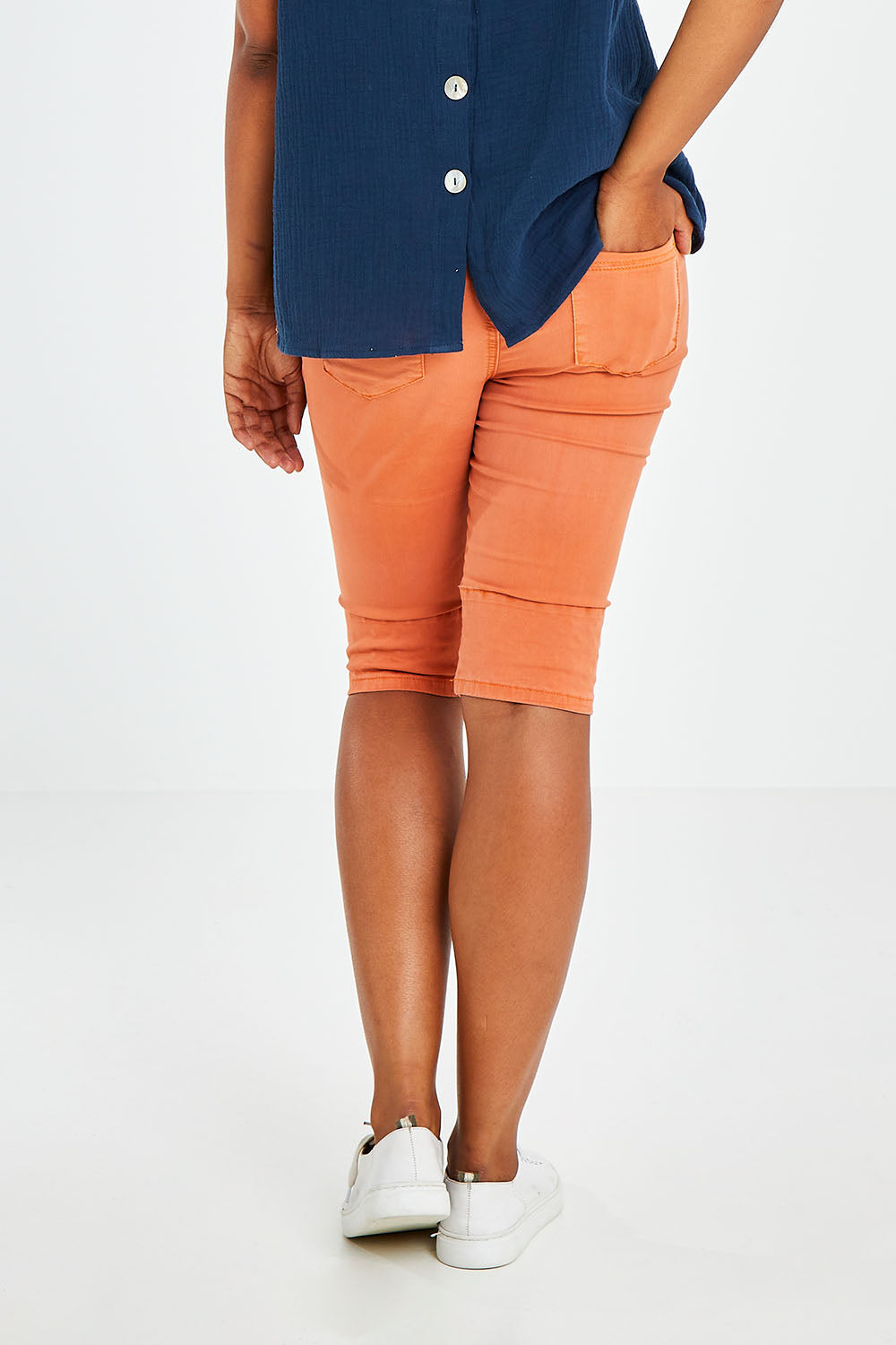 Model Olivia wearing size S of the Jogger Short in colour Orange, from the back