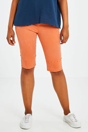 Model Olivia wearing size S of the Jogger Short in colour Orange, from the front, cropped image