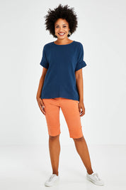 Model Olivia wearing size S of the Jogger Short in colour Orange, from the front, showing the whole outfit