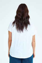 Model Laura wearing size L of the Star Print Top in colour White (White), from the back