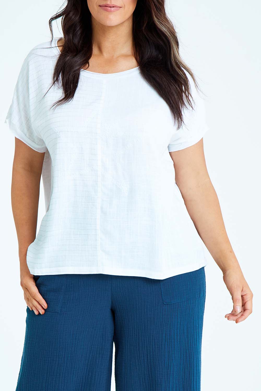 Model Laura wearing size L of the Star Print Top in colour White (White), from the front, cropped image