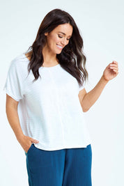Model Laura wearing size L of the Star Print Top in colour White (White), from the front, cropped image