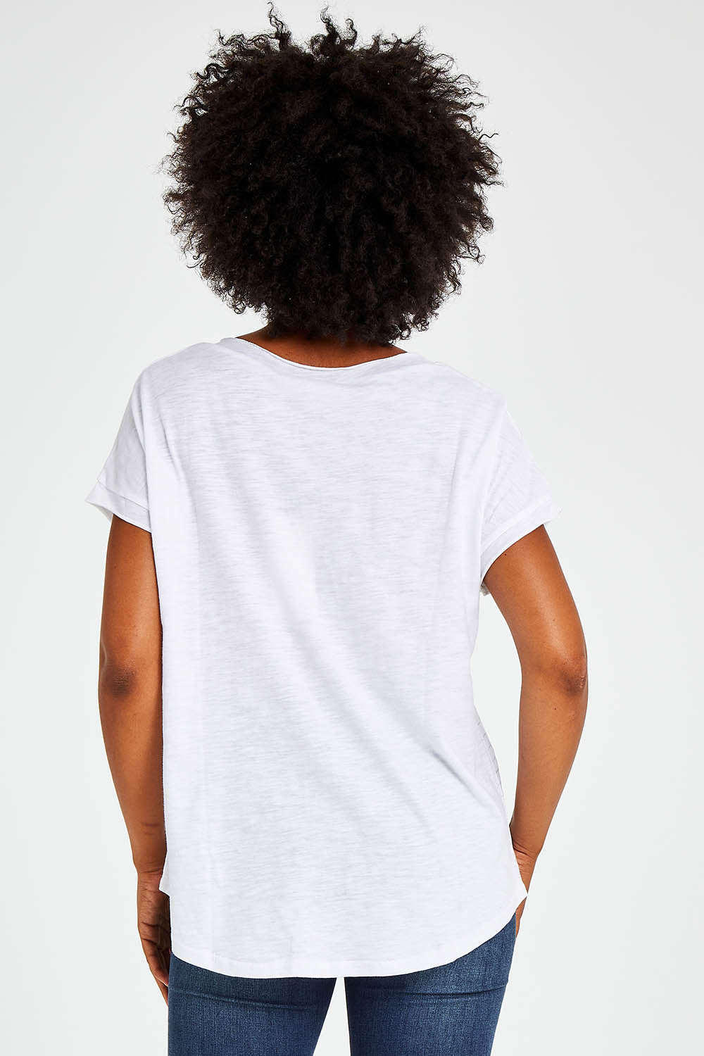Model Olivia wearing size S of the Star Print Top in colour White (White), from the back