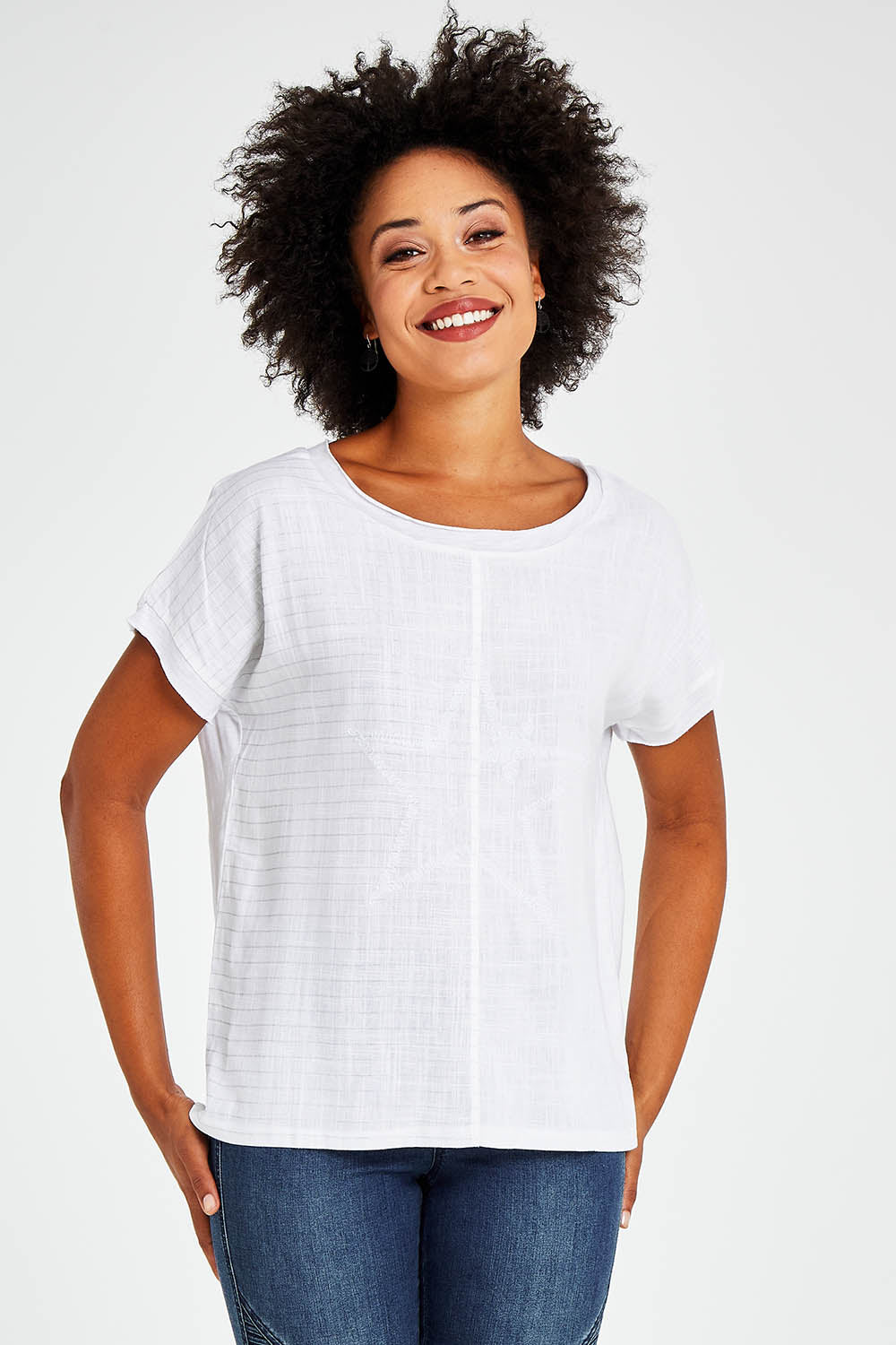 Model Olivia wearing size S of the Star Print Top in colour White (White), from the front, cropped image