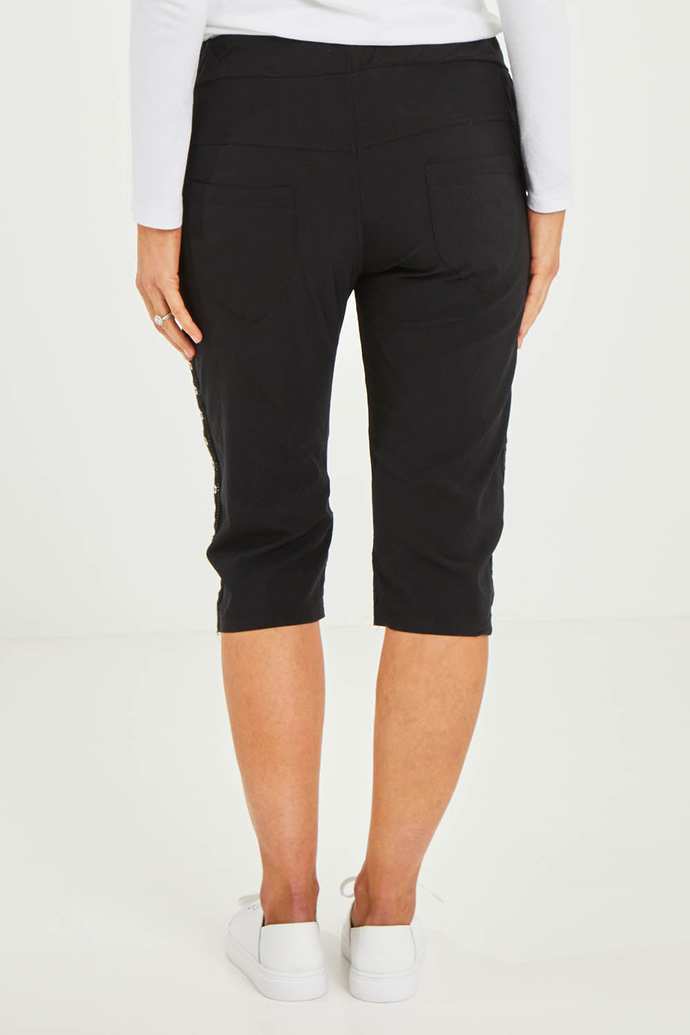 Model Kelly wearing size S of the Crushed Jean Short in colour Black (Black), from the back
