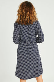 Model Emma wearing size S of the Alexa Dress in colour Navy (Blue), from the back